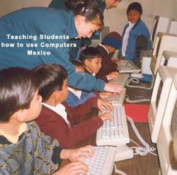 Merit students teaching students how to use computers in Mexico